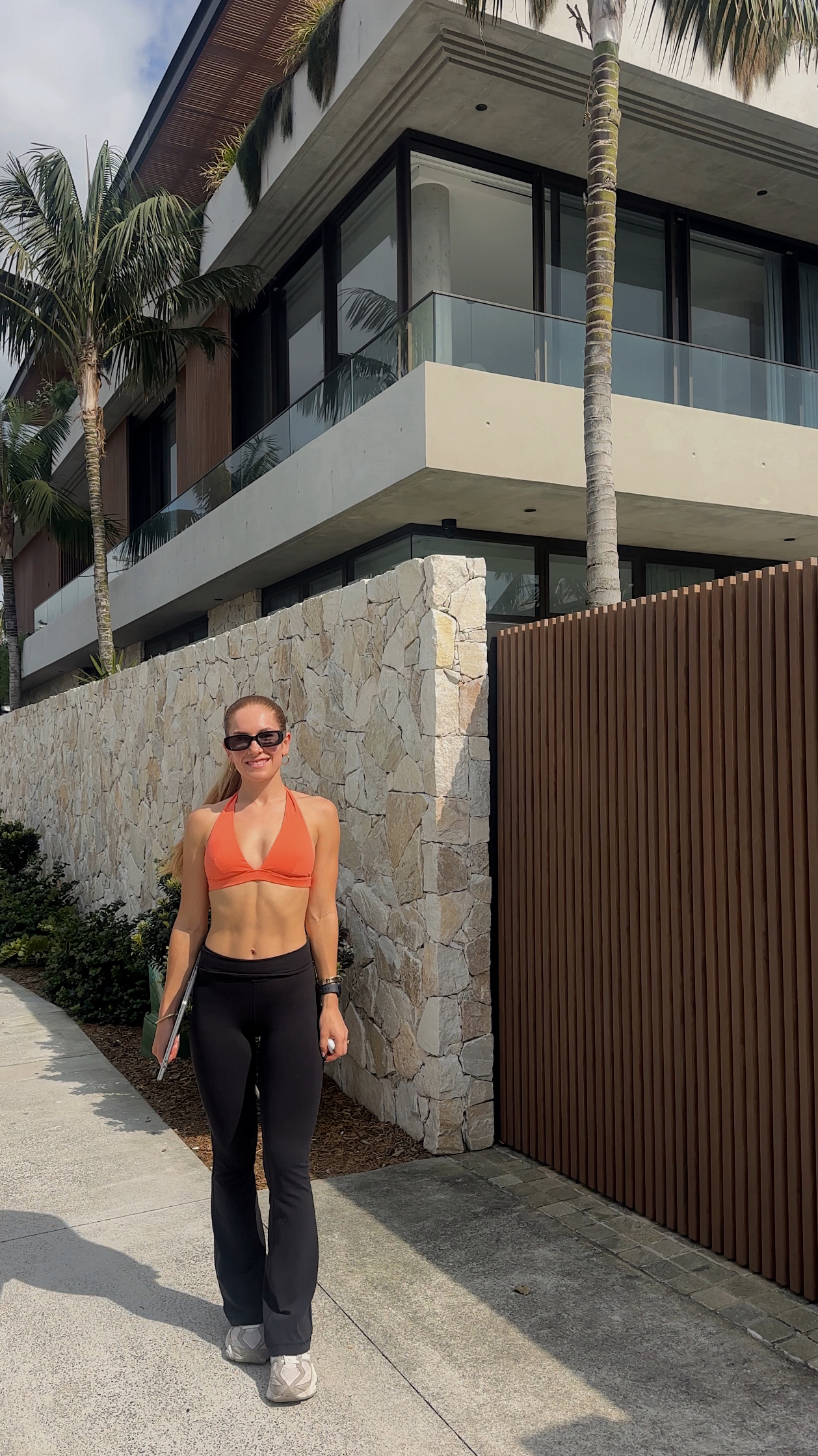 WellWithCat – Your Daily Habits Create Your Reality – health and wellness blogger in orange crop top, casual fitness outfit