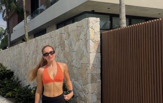 Cat Martin – Your Daily Habits Create Your Reality – fitness lifestyle photo in orange crop top and black Lululemon leggings